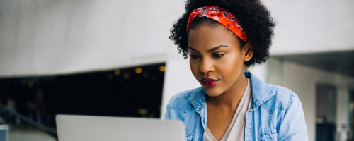 Woman sitting down using laptop